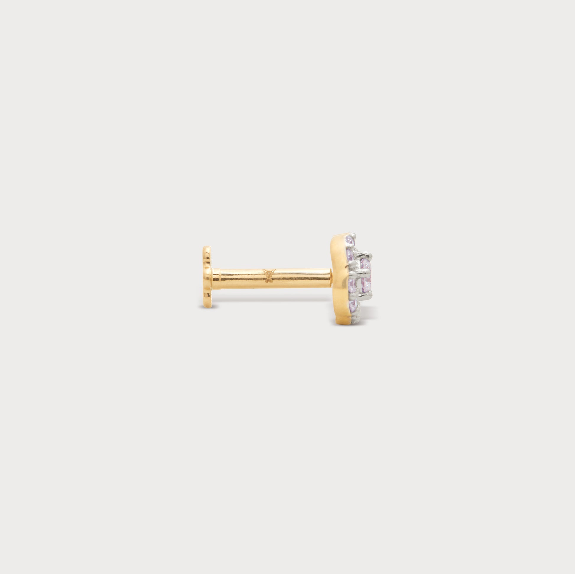 The Halo Spark Nose Pin, a luxurious yellow gold nose pin featuring sparkling pink diamonds in a halo setting. Exquisite diamond jewellery for nose piercings.