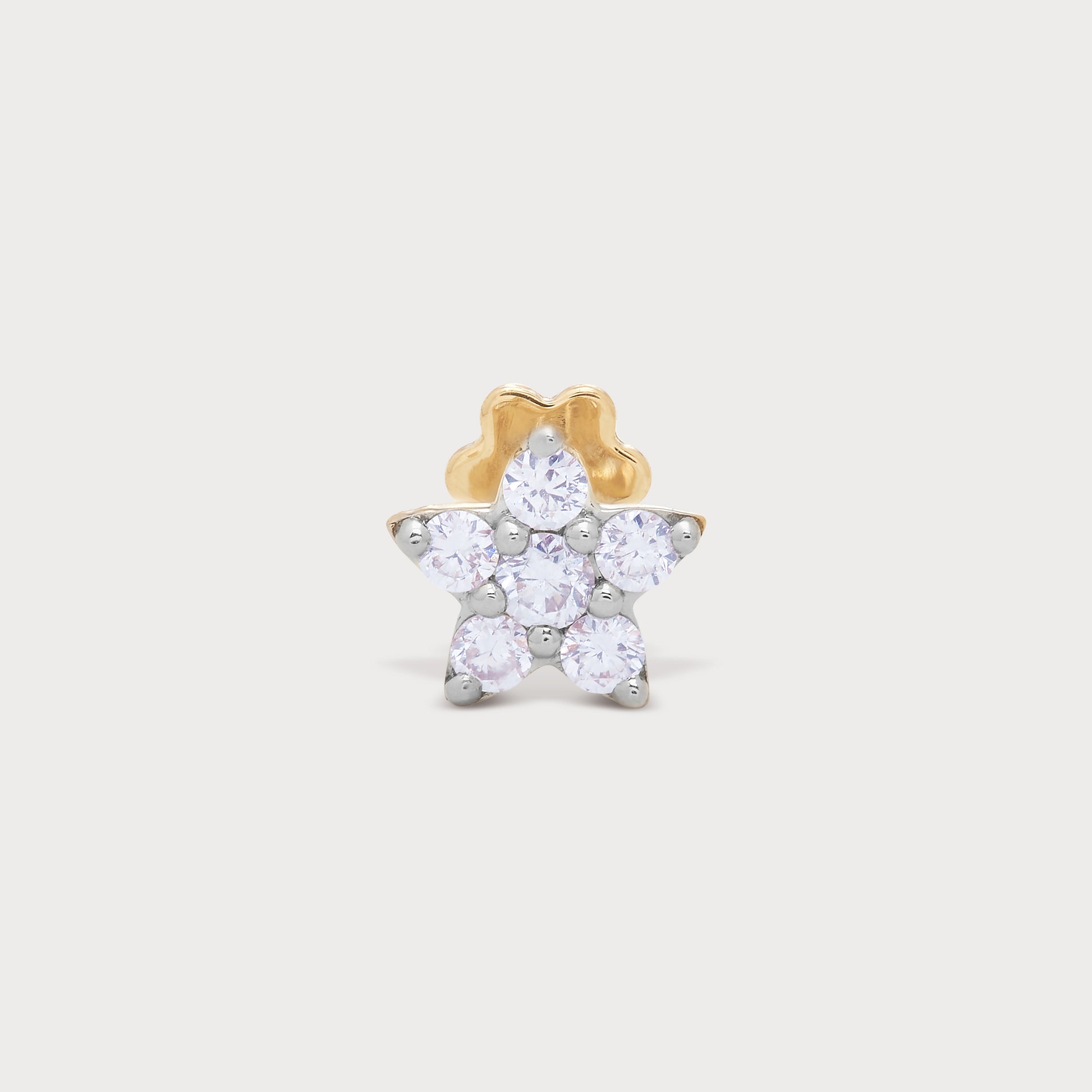 The Stellar Nose Pin, a star-shaped diamond nose pin crafted in yellow gold and silver, featuring multiple brilliant diamonds. Ideal for adding a dazzling touch, this piece is available at our e-commerce diamond jewellery store.