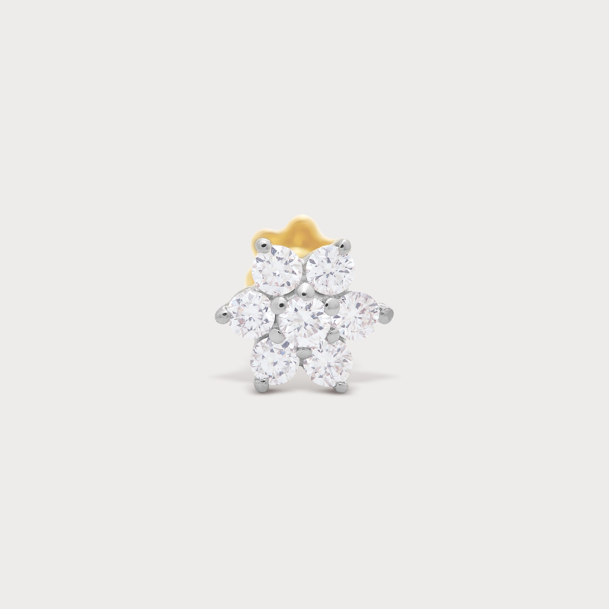 The Flora diamond nose pin, a floral design featuring brilliant round diamonds set in gold. Elegant diamond jewellery for women.