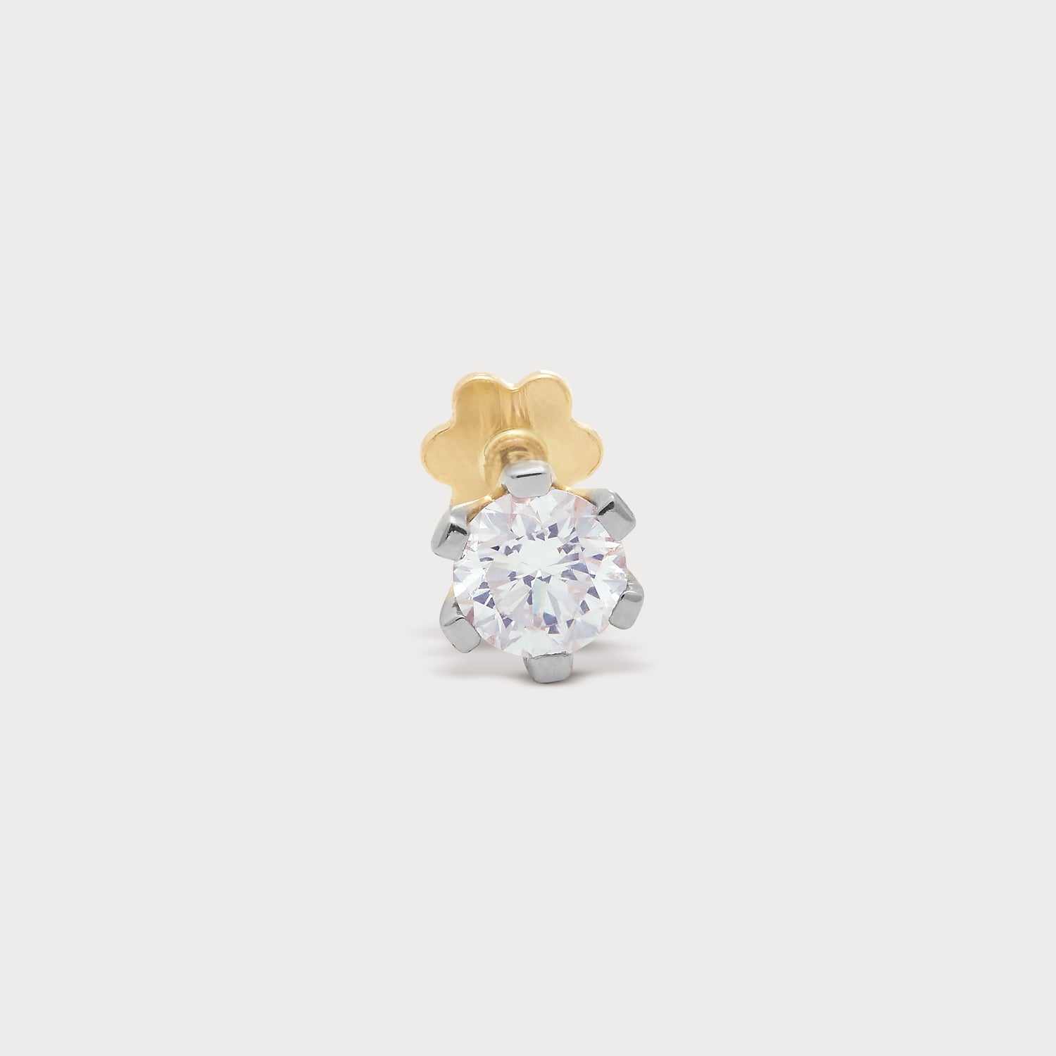 The Stud Nose Pin featuring a dazzling round brilliant cut diamond in a white gold six-prong setting with a yellow gold backing, ideal for diamond jewellery collections.