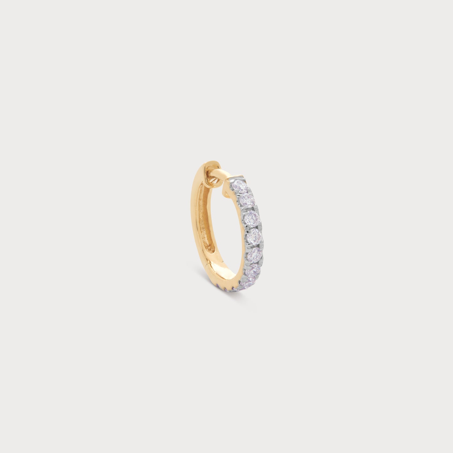 The Eternity Loop Diamond Nose Pin in gold. A delicate gold hoop nose ring featuring a line of sparkling diamonds for a luxurious look. Perfect for daily wear or special occasions, available at our diamond jewelry e-commerce store.