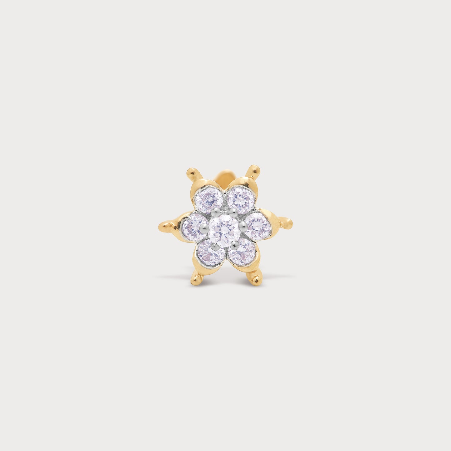 Sparkling gold floral diamond stud earring or nose pin with brilliant round diamonds.